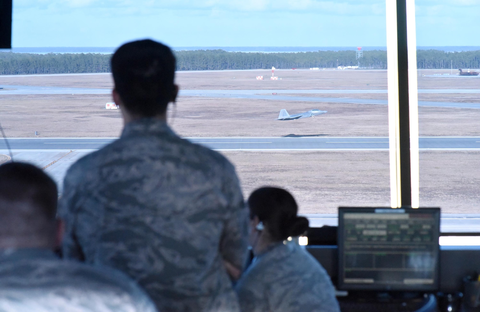 U.S. Air Force air traffic controllers from the 325th Operations Support Squadron at Tyndall Air Force Base, Fla., track an F-22 Raptor as it takes off on the Tyndall AFB flightline during Checkered Flag 17-1 Dec. 12, 2016. Tyndall’s air traffic controllers were responsible for an additional 40 aircraft during concurrent exercises Checkered Flag 17-1 and Combat Archer 17-3. (U.S. Air Force photo by Senior Airman Solomon Cook/Released)