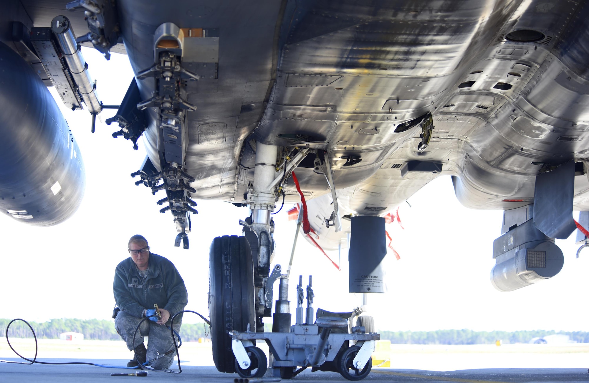 U.S. Air Force Tech. Sgt. Tessa Holtz, 33th Aircraft Maintenance Squadron from Mountain Home Air Force Base, Idaho, checks the tire pressure of an F-15 E Strike Eagle prior to a training sortie during Checkered Flag 17-1 at Tyndall Air Force Base, Fla., Dec. 14, 2016. During the exercise, Tyndall AFB, Mountain Home AFB and their partners brought together more than 90 aircraft to take part in the two week-long exercise. (U.S. Air Force photo by Senior Airman Solomon Cook/Released)