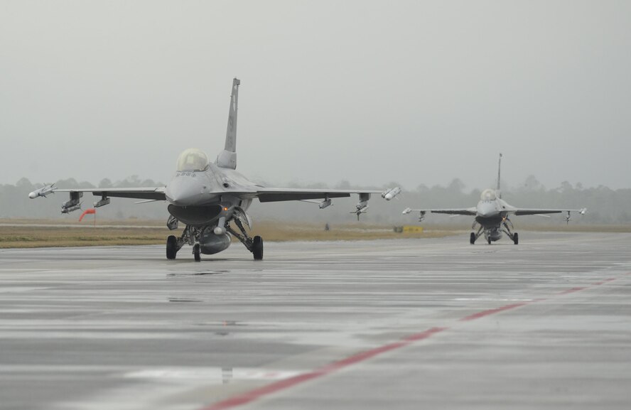 Two U.S. Air Force F-16 Fighting Falcons from the 55th Fighter Squadron, Shaw Air Force Base, South Carolina, taxi before take-off at Tyndall Air Force Base, Fla., Dec. 5, 2016. The 55th FW and other Air Force units visited Tyndall AFB to participate in Checkered Flag 17-1, a large-scale total force integration exercise. (U.S. Air Force photo by Senior Airman Solomon Cook/Released)