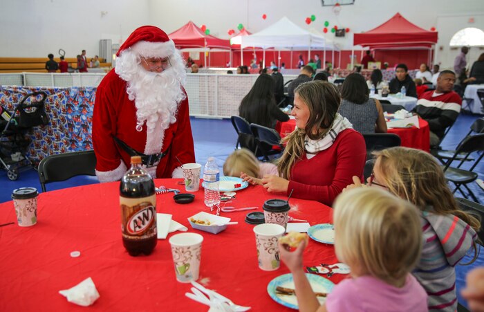 Service members and their families and friends attend the annual Depot Christmas Party at Marine Corps Recruit Depot San Diego, Dec. 17, to get into the holiday spirit. The party featured an appearance from Santa, playing games, winning prizes and enjoying food.