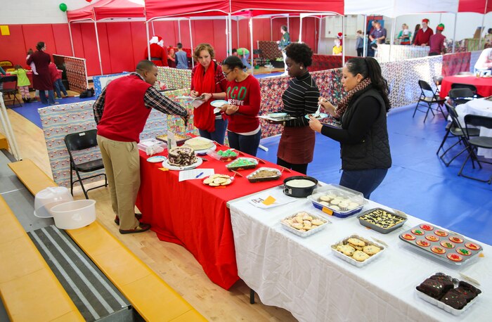 Service members and their families and friends attend the annual Depot Christmas Party at Marine Corps Recruit Depot San Diego, Dec. 17, to get into the holiday spirit. The party featured an appearance from Santa, playing games, winning prizes and enjoying food.