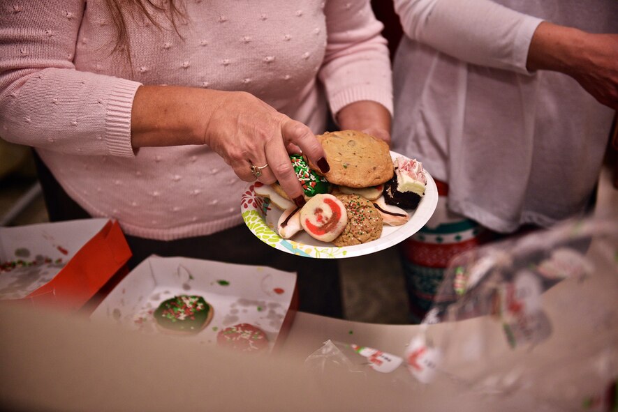 Members of the 932nd Airlift Wing Key Spouse Program build plates of cookies to distribute throughout the Wing, Dec. 4, 2016, Scott Air Force Base, Illinois. The Key Spouse is an official unit/family program designed to enhance readiness and establish a sense of Air Force community. It is a commander’s program that promotes partnerships with unit leadership, volunteer Key Spouses appointed by the commander, families, the Airman & Family Readiness Center and other community and helping agencies. The program has been standardized across the Air Force to address the needs of all military families with special emphasis on support to families across the deployment cycle. (U.S. Air Force photo by Tech. Sgt. Christopher Parr)