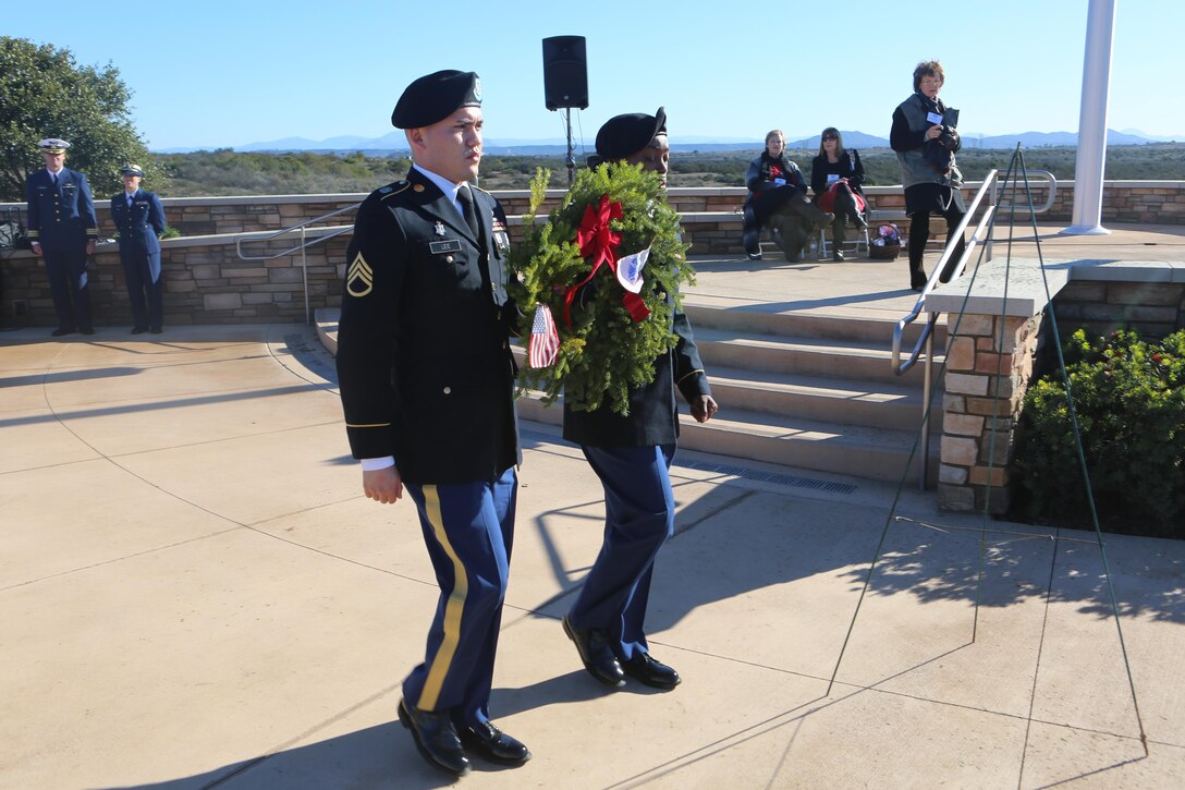 Service members participate in a wreath laying ceremony during the annual Wreaths Across America event at Miramar National Cemetery, San Diego, Calif., Dec. 17.  Through Wreaths Across America, more than 1.2 million wreaths were placed in 1,228 cemeteries across the country. The mission of Wreaths Across America is to remember fallen U.S. troops, honor those who serve and teach new generations about the value of freedom through the service and sacrifice of veterans. (U.S. Marine Corps photo by Lance Cpl. Jacob Pruitt/Released)