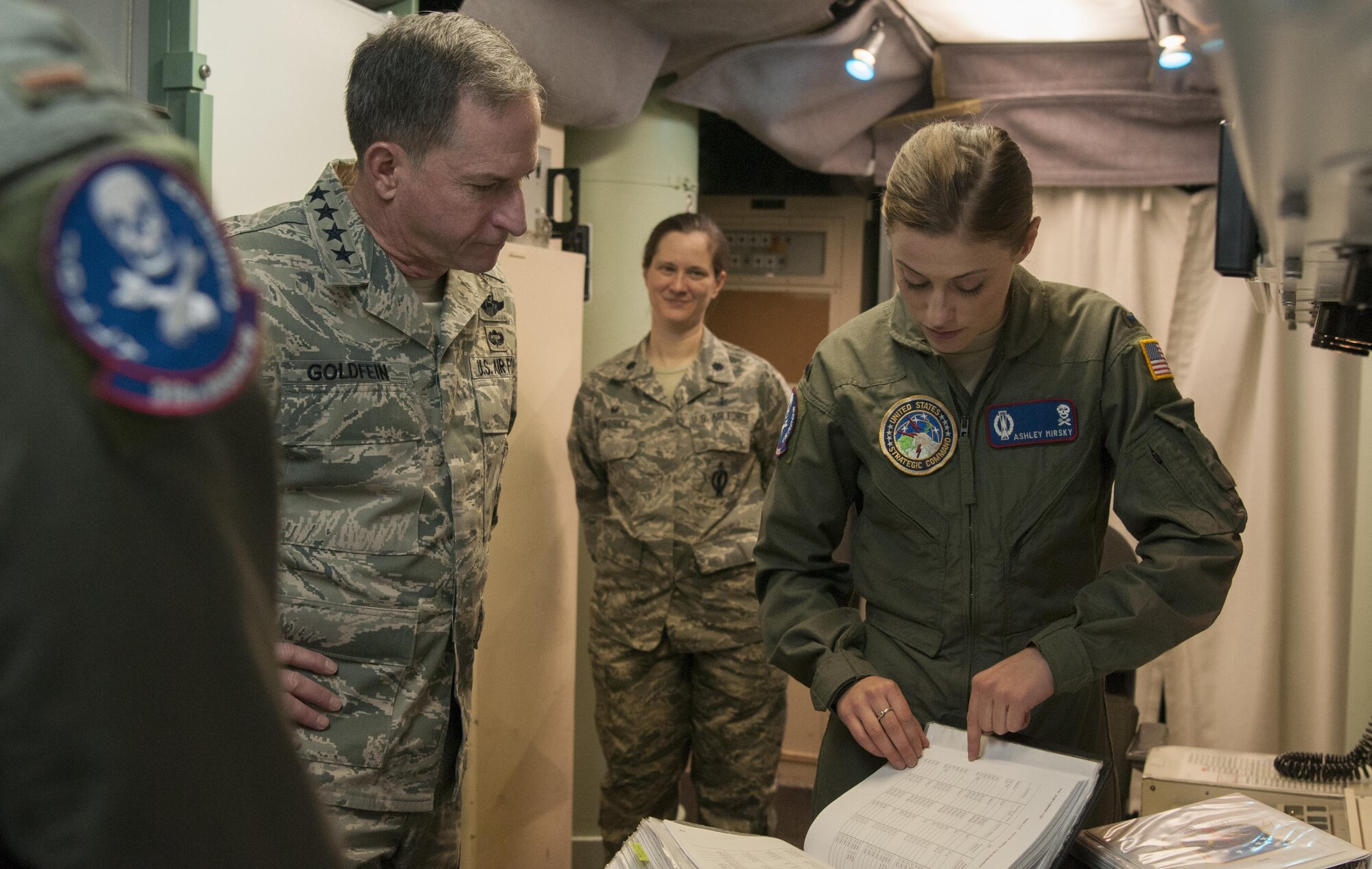 First Lt. Ashley Mirsky, 319th Missile Squadron missile combat crew commander explains how all launch control centers communicate with one another to Air Force Chief of Staff Gen. David L. Goldfein during a familiarization tour at a missile alert facility in the 90th Missile Wing missile complex, Dec. 19, 2016. The 90th MW contributes to the nation’s strategic defense by sustaining and operating 150 Minuteman III ICBMs and the associated launch facilities which cover 9,600 square miles across three states. (U.S. Air Force photo by Staff Sgt. Christopher Ruano)