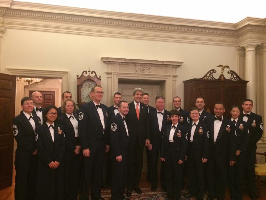 Secretary of State John Kerry poses with the Air Force Strings after their performance at the Press Corps Holiday Reception at the State Department. (US Air Force Photo/released)