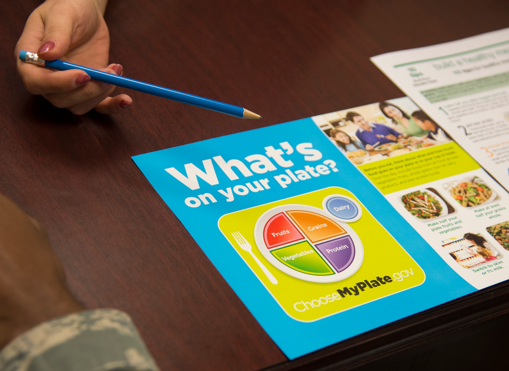 Sandra Stuart, 23d Medical Group health promotion dietitian, gives an Airman resources to help him control his diet, Dec. 19, 2016, at Moody Air Force Base, Ga. Stuart’s services are available at no cost to all active duty, dependents, and retirees. (U.S. Air Force photo by 2d Lt. Kaitlin Toner)