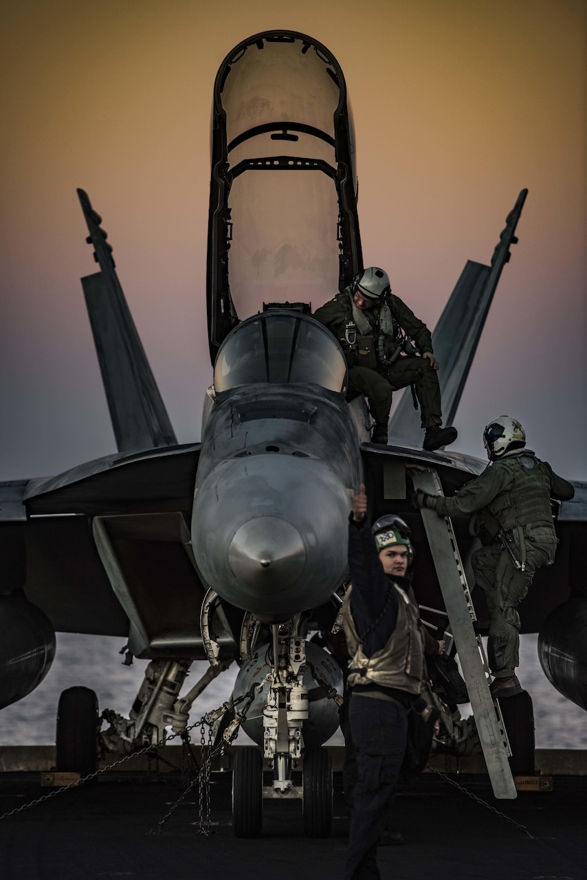 A sailor gives the thumbs-up after Navy pilots conduct preflight checks on an F/A-18F Super Hornet on the flight deck of the aircraft carrier USS Dwight D. Eisenhower in the Mediterranean Sea, Dec. 11, 2016. Navy photo by Petty Officer 2nd Class Ryan Kledzik