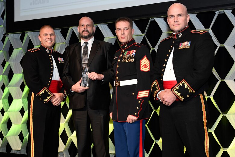 From left, U.S. Marine Corps Lt. Col. Carlson, air operations officer, Robert Rudolph, Marine Corps Community Service special events program manager, U.S. Marine Corps GySgt. Michael Nelson, Air Traffic Control tower chief, and U.S. Marine Corps Maj. Nathan Hoff, assistant operations officer, received the Dick Schram Memorial Community Relations Award at the Chairman’s Banquet at the annual International Council of Air Shows Convention in Las Vegas, Nevada, Dec. 8, 2016. The award, the highest recognition given to military bases by the International Air Council of Air Shows, was earned for the 2016 and 2016 MCAS Iwakuni Friendship Day Air Shows for the excellent relationship between MCAS Iwakuni and its neighbors. (Courtesy photo by Larry Grace)