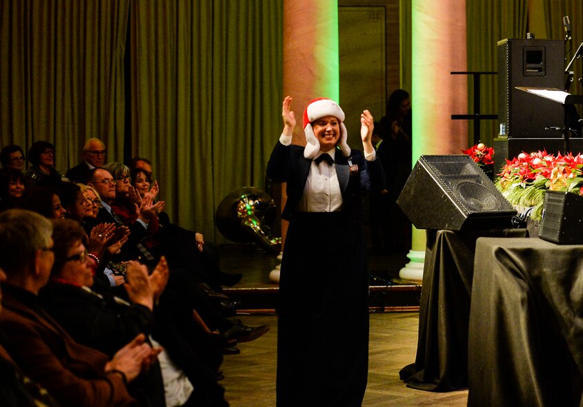 A U.S. Air Forces Europe Band member interacts with audience members during a Christmas concert at Kaiserslautern, Germany, Dec. 16, 2016. The event aimed to celebrate the longstanding economic, strategic, social, and cultural partnership between U.S. military members and local nationals in Germany. (U.S. Air Force photo by Airman 1st Class Joshua Magbanua)