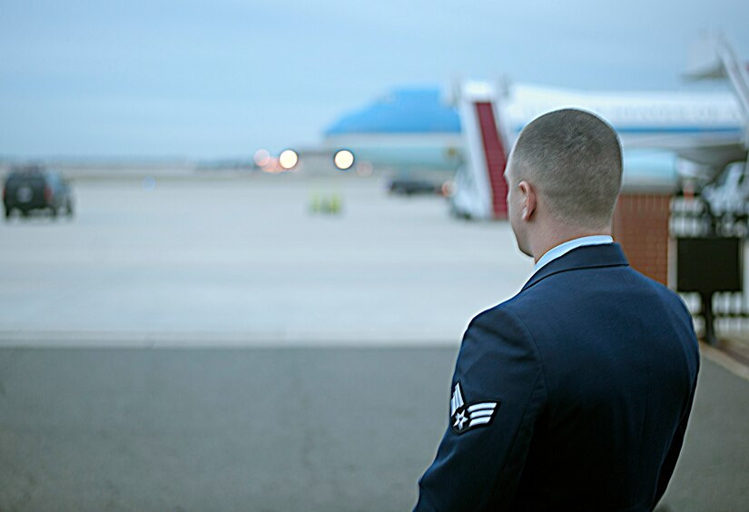 Senior Airman Steven Shorter, 89th Aerial Port Squadron special air mission agent, looks out at Air Force One as he awaits the arrival of President Barack Obama on Marine One at Joint Base Andrews, Md., Dec. 16, 2016. The president departed on Air Force One for Hawaii to spend the holidays with the First Family. (U.S. Air Force photo by Staff Sgt. Joe Yanik)