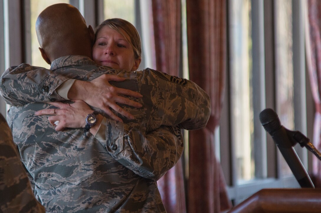 Chief Master Sgt. Nathaniel Perry, left, 79th Medical Wing command chief master sergeant, hugs Chief Master Sgt. Beth Topa, right, retired 11th Wing command chief master sergeant, at her retirement ceremony on Joint Base Andrews, Md., Dec. 20, 2016. Topa officially retired on Dec. 9 after serving 24 years in the U.S. Air Force.