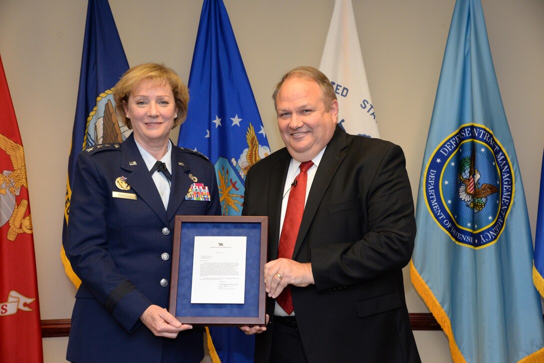 Air Force Lt. Gen. Wendy Masiello, Defense Contract Management Agency director, recognizes Jim Russell, her deputy, at a Dec. 19 retirement ceremony at Fort Lee, Virginia. Russell retired after 36 years of federal service, mostly with DCMA or its predecessor organizations. (DCMA photo by Stephen Hickok)