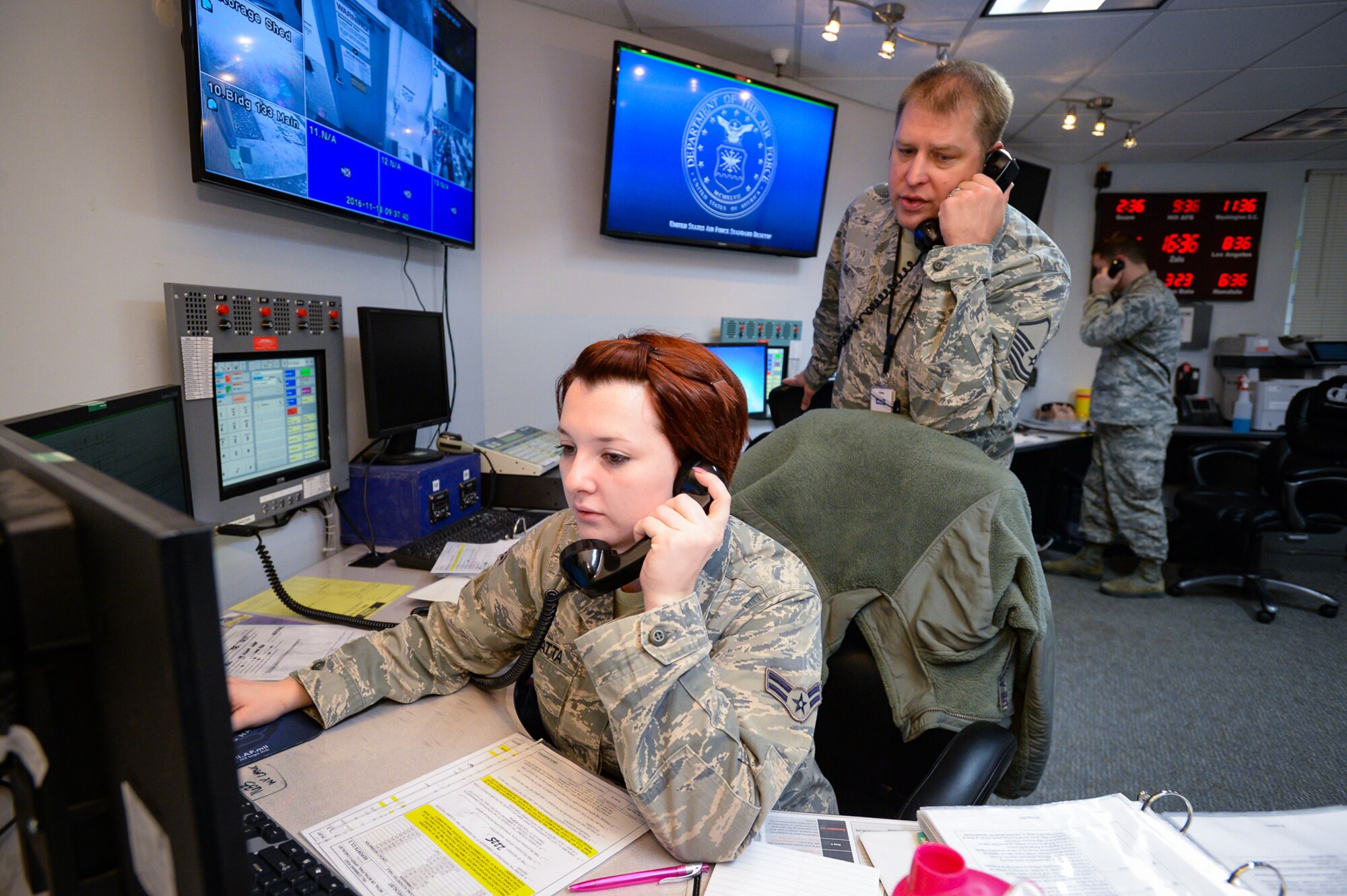 Emergency actions controllers Airman 1st Class Meggan Van Atta, Master Sgt. Jeremy Smith, and Senior Airman Jeremy Odneal answer response calls in the Hill Command Post, Nov. 18, 2016. Command post specialists ensure base operations and communications run efficiently and effectively under any circumstance by providing command, control, communications and information support. (U.S. Air Force photo by R. Nial Bradshaw)