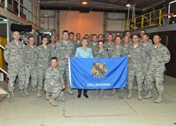 Oklahoma Gov. Mary Fallin presents the state flag to members of the Oklahoma Air National Guard deployed to the 380th Expeditionary Civil Engineering Squadron at an undisclosed location in Southwest Asia, Dec. 7, 2016. During a visit to deployed locations with Wis. and Okla. governors, Fallin made a point to show her support to members deployed from her state’s Air National Guard units. (U.S. Air Force photo by Tech. Sgt. Christopher Carwile)