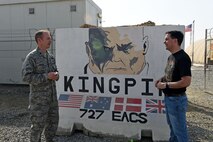U.S. Air Force Lt. Col. Billy, 727th Expeditionary Air Control Squadron, describes the significance of the name “Kingpin” for the 727th EACS to Wisconsin Gov. Scott Walker at an undisclosed location in Southwest Asia, Dec. 7, 2016. Even though the Marvel character “Kingpin” is a villain, the 727th EACS identifies with a mission of being all-seeing and able to exercise wide-reaching control. (U.S. Air Force photo by Tech. Sgt. Christopher Carwile)