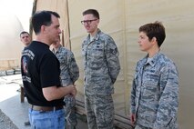 Wisconsin Gov. Scott Walker talks with 1Lt. Cedar and Staff Sgt. Reid, 727th Expeditionary Air Control Squadron members, about their jobs and how their time deployed to an undisclosed location in Southwest Asia is going, Dec. 7, 2016. Cedar and Reid are both members of the 115th Fighter Wing, Wisconsin Air National Guard, deployed to support 380th Air Expeditionary Wing missions. (U.S. Air Force photo by Tech. Sgt. Christopher Carwile)
