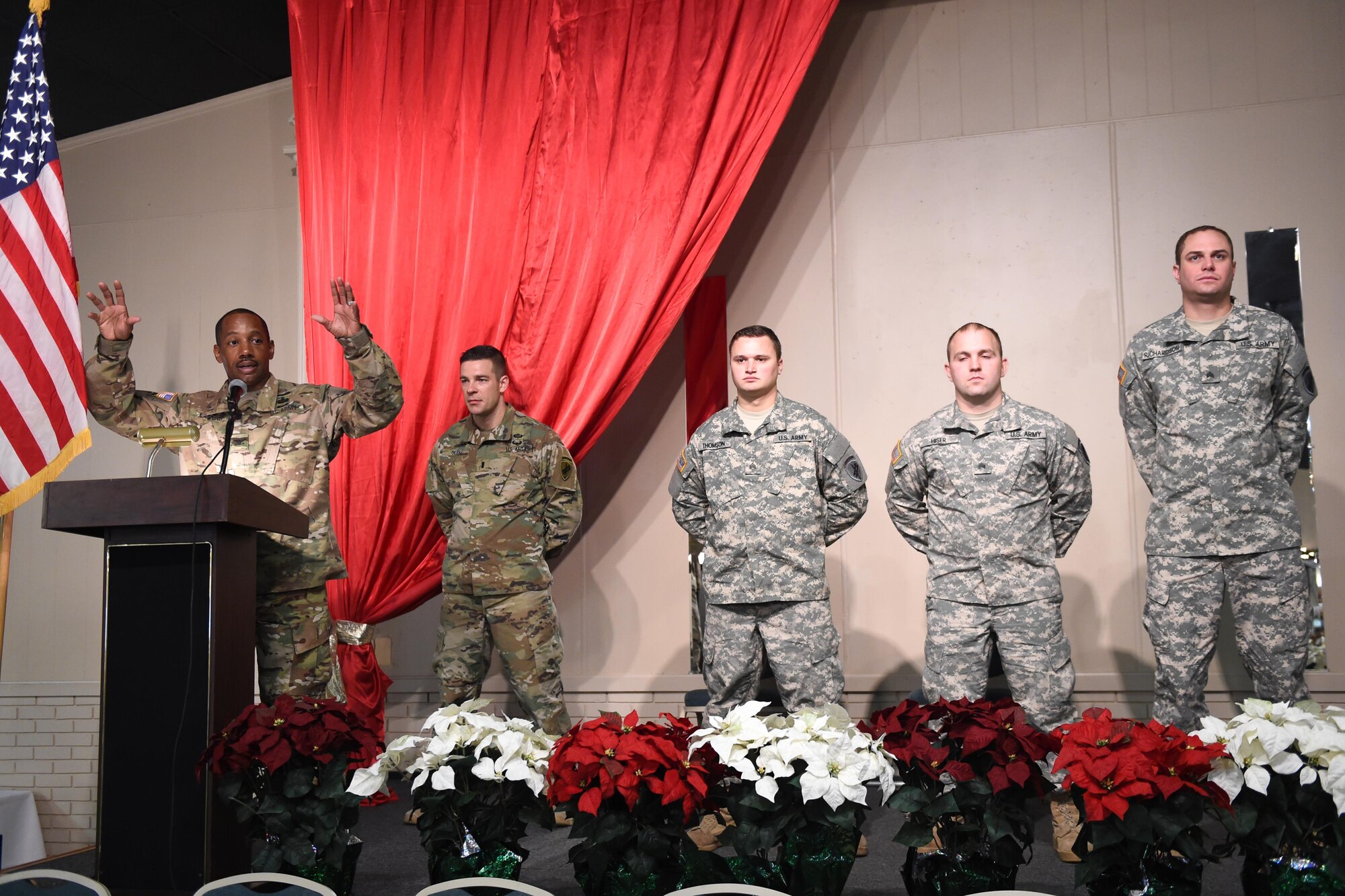 From right to left, Sgt. Nathan Richardson, 316th Psychological Operations Company PSYOP sergeant, Sgt. Daniel Hiser, 316th PSYOP Co. PSYOP sergeant and Sgt. Stephen Thompson, 209th Quartermaster Company mechanic, stand in formation as Col. Jesse Manning, 2nd Psychological Operations Group commander, speaks to Soldiers and their families during a promotion ceremony in Kokomo, Ind., Dec. 10, 2016. The ceremony was conducted during a family day event that included a Welcome Home Warrior-Citizen award ceremony followed by holiday festivities. (U.S. Air Force photo/Tech. Sgt. Benjamin Mota)