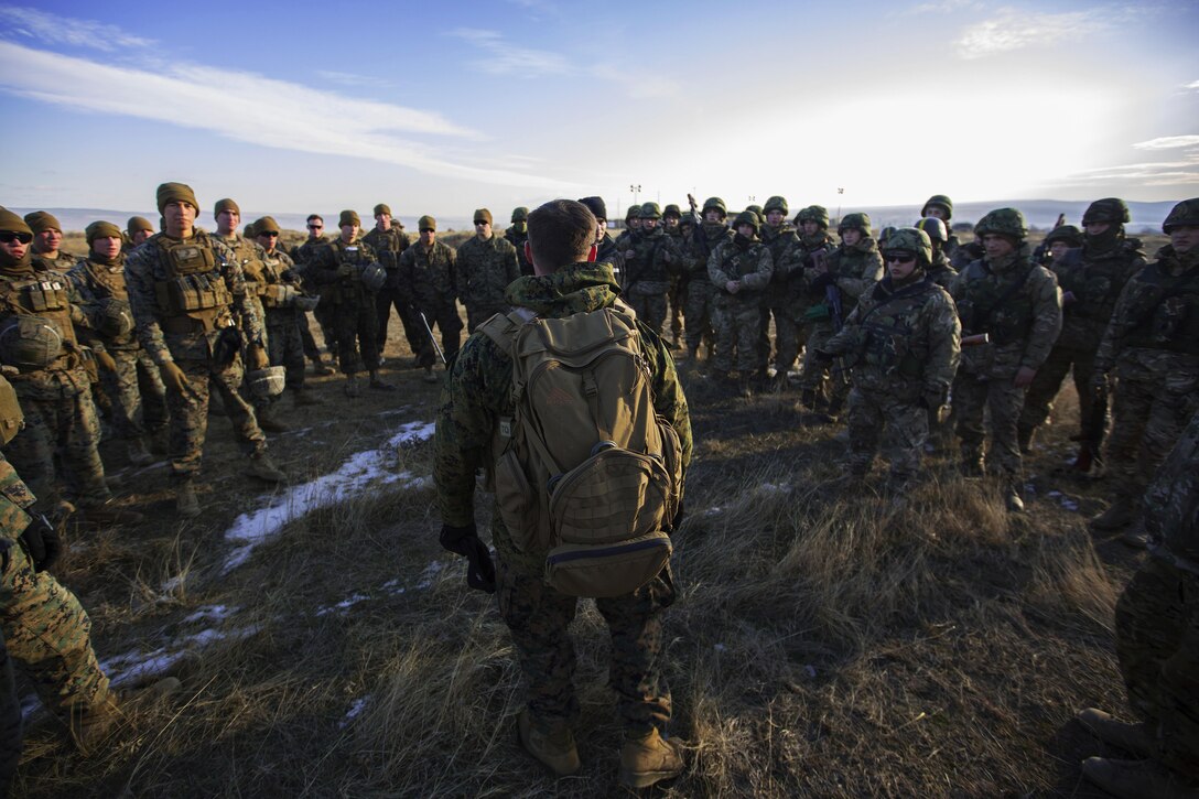 A Marine briefs fellow Marines and Ukrainian soldiers for a simulated casualty evacuation drill during Platinum Lion at Novo Selo Training Area, Bulgaria, Dec. 16, 2016. The exercise allows Marines in Europe to train with eight other partner nations in the Black Sea, Balkan and Caucasus regions to enhance collective professional military capabilities and promote regional stability. Marine Corps photo by Lance Cpl. Timothy J. Lutz