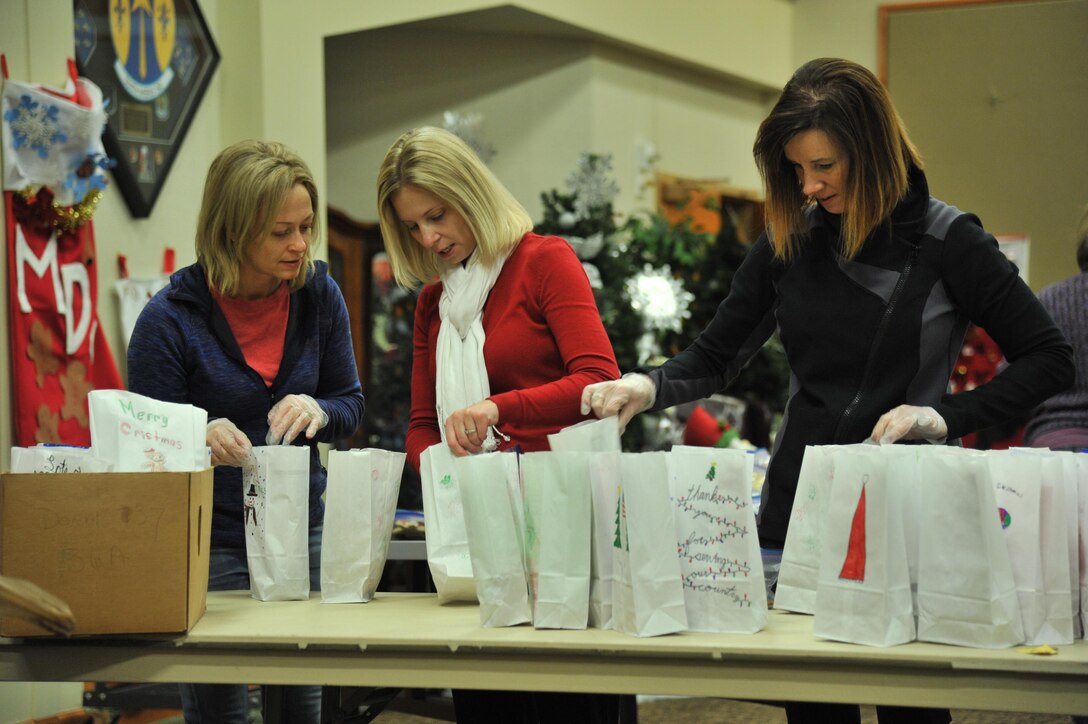 Community and base volunteers organize bags filled with cookies during the annual Cookie Express at the Grizzly Bend Dec. 15, 2016, at Malmstrom Air Force Base, Mont. The bags were decorated by students from the Great Falls school district. (U.S. Air Force photo/John Turner)