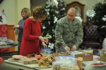 Sharon Lynde, 1st Liberty Credit Union director of communication and product development, and Chief Master Sgt. Thomas Stiles, 341st Missile Wing command chief, place cookies in bags during the annual Cookie Express at the Grizzly Bend Dec. 15, 2016, at Malmstrom Air Force Base, Mont.  Every year the base hosts the event to provide dorm residents and 24-hour work centers with home-baked goods during the holiday season. (U.S. Air Force photo/John Turner)