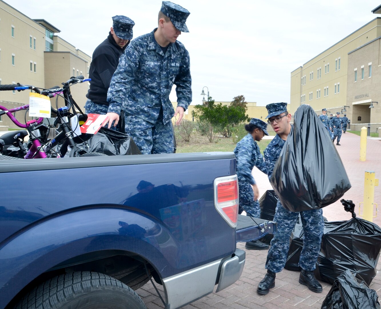 Students load toys into a truck outside of Anderson Hall at the Medical Education and Training Campus, or METC, at Joint Base San Antonio-Fort Sam Houston, wrapping up METC's fifth annual toy drive. Anderson Hall was named after Petty Officer 3rd Class Christopher Anderson who was killed in action Dec. 4, 2006 in Ramadi, Iraq, while serving with the 1st Battalion, 6th Marines. Every year, Sailors at METC organize a toy drive in Anderson's honor to collect donations for Toys for Tots.