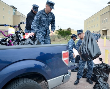 Students load toys into a truck outside of Anderson Hall at the Medical Education and Training Campus, or METC, at Joint Base San Antonio-Fort Sam Houston, wrapping up METC's fifth annual toy drive. Anderson Hall was named after Petty Officer 3rd Class Christopher Anderson who was killed in action Dec. 4, 2006 in Ramadi, Iraq, while serving with the 1st Battalion, 6th Marines. Every year, Sailors at METC organize a toy drive in Anderson's honor to collect donations for Toys for Tots.