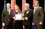 Mary Ann Spott (second from left), Ph.D., deputy director of the Joint Trauma System, or JTS, at the U.S. Army Institute of Surgical Research, or USAISR, at Joint Base San Antonio-Fort Sam Houston, is presented the Distinguished Civilian Service Award during an award ceremony at the Pentagon Nov. 6. Pictured from left to right with Spott are Bob Work, Deputy Secretary of Defense; Capt. (Dr.) Zsolt Stockinger, JTS director; and Michael Rhodes, director of administration and management, Office of the Secretary of Defense.
