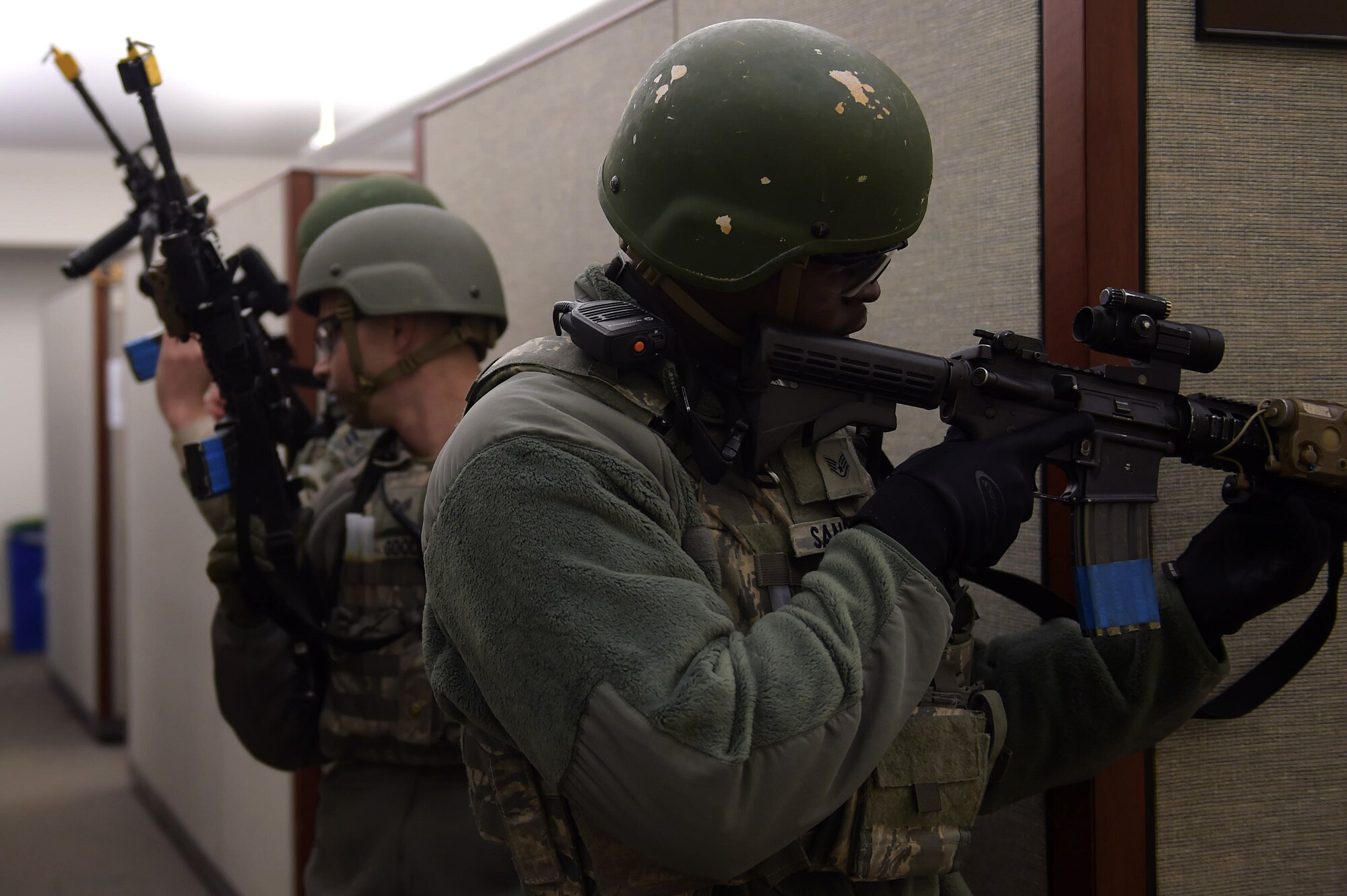 U.S. Air Force Staff Sgt.  Jarrett Sanders, 633rd Security Forces Squadron Base Defense Operations Center controller, and his team clear the 633rd Civil Engineer Squadron building during an active shooter exercise at Joint Base Langley-Eustis, Va., Dec. 15, 2016. After the active shooter was apprehended, more members of the 633rd SFS, patrolled  the building to ensure there were no other threats. (U.S. Air Force photo by Senior Airman Kimberly Nagle)