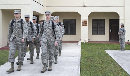 Master Sgt. Kelli Jackson (right), 558th Flying Training Squadron military training leader and superintendent, watches as a class of basic sensor operator technical training students march to class at Joint Base San Antonio-Randolph Dec. 14, 2016. An MTLs basic duty is to help non-prior service Airmen transition to military life, continuing the training they received at basic military training. (U.S. Air Force photo illustration by Airman 1st Class Lauren Parsons/Released)