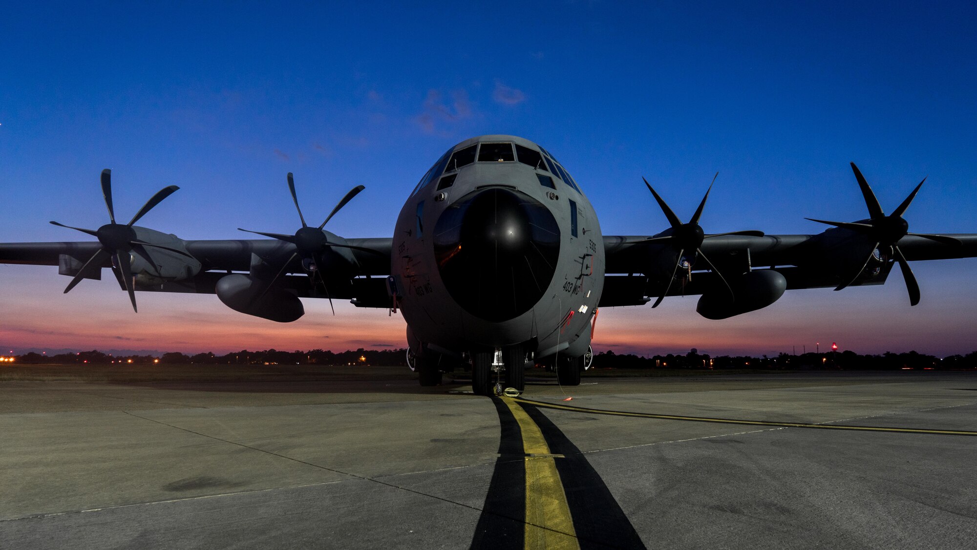 A 403rd Wing WC-130J Super Hercules aircraft is parked on the Keesler Air Force Base flight line as the sun sets. (U.S. Air Force photo/Staff Sgt. Shelton Sherrill)