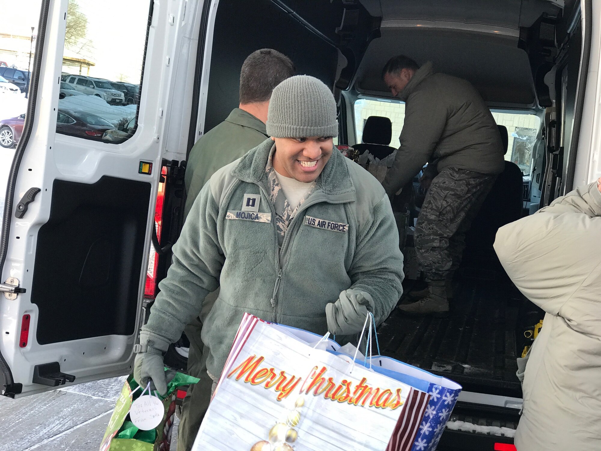 Capt. William-Joseph Mojica, 934th Airlift Wing public affairs officer, unloads gifts at the Minnesota Veteran's Home Dec. 15.