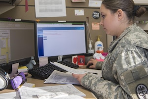 U.S. Army Staff Sgt. Valerie Garvin, Public Health Command District animal care specialist, budgets the Veterinary Treatment Facility income at Joint Base Andrews, Md., Dec. 20, 2016. As an animal care specialist, she manages and files everything in the facility including budgets, medications and patients. (U.S. Air Force photo by Airman 1st Class Valentina Lopez)