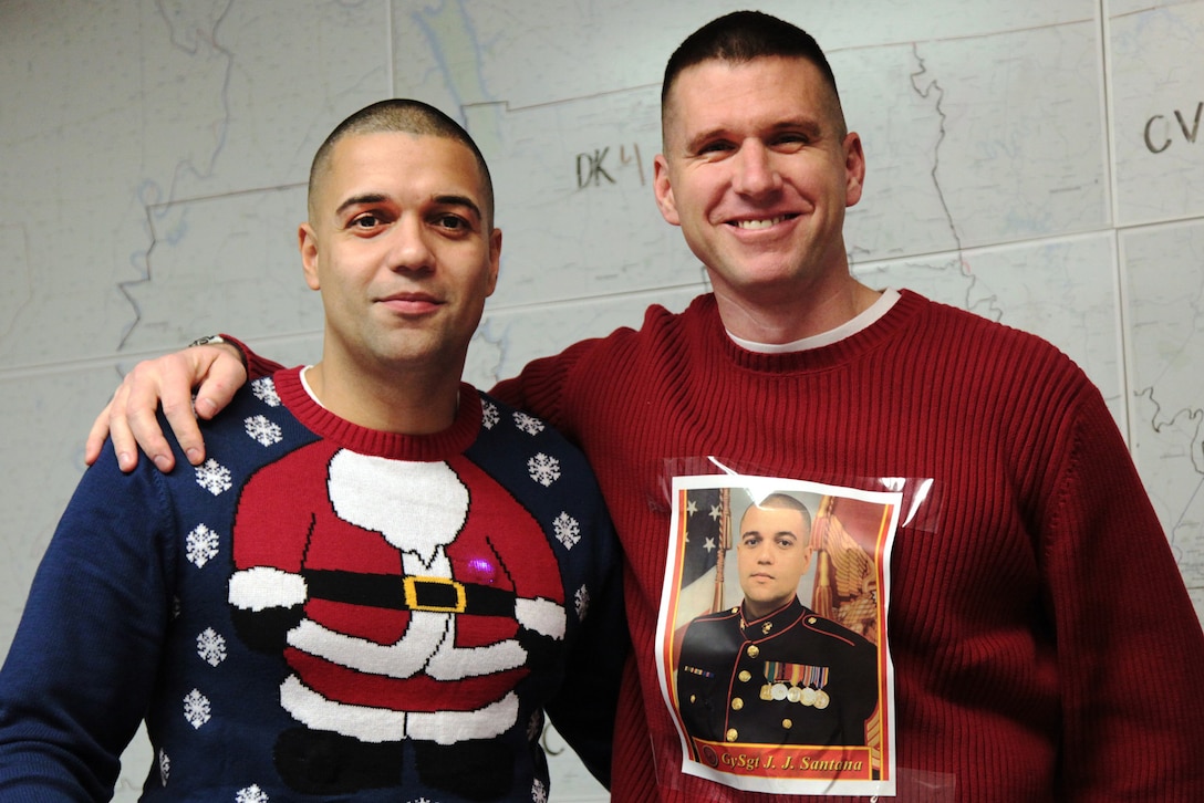 In the spirit of the holiday season, Gunnery Sgt. Jorge Santana (left) and Maj. Jonathan Landers pose for a photo together for the ugliest sweater contest during Recruiting Station Tennessee's Christmas party on Dec. 19, 2016, in Nashville, Tennessee. Santana is the assistant recruiting instructor and Landers is the commanding officer of Recruiting Station Tennessee. (Official Marine Corps photo by Sgt. Michael Iams/Released)
