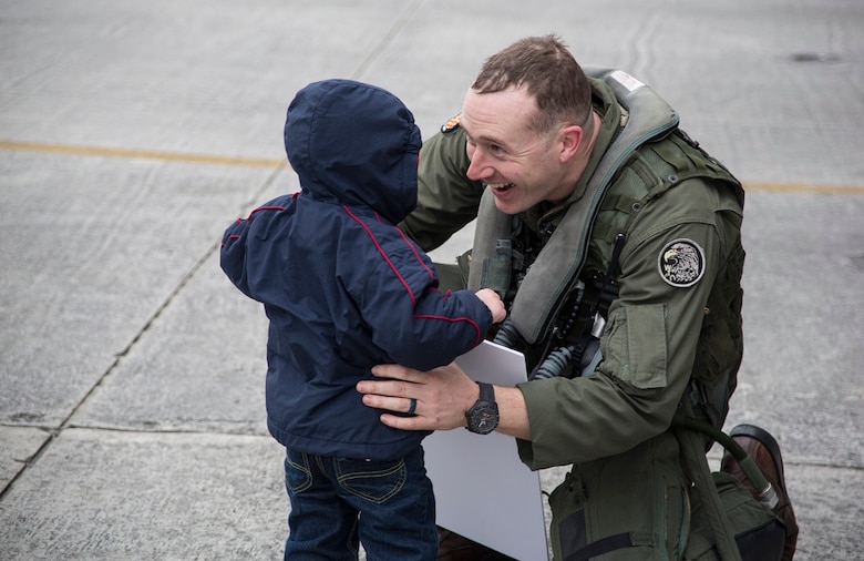 Maj. Nicholas Tyson is welcomed by his son Liam during a homecoming at Marine Corps Air Station Cherry Point, N.C., Dec. 19, 2016 A detachment of Marines from Marine Attack Squadron 542, Marine Aircraft Group 14, 2nd Marine Aircraft Wing, were attached to Marine Medium Tiltrotor Squadron 264 (Reinforced), Marine Aircraft Group 26, 2nd MAW, 22nd Marine Expeditionary Unit. The 22nd MEU, deployed with the Wasp Amphibious Ready Group, conducted naval operations in support of U.S. national security interests in Europe.  Tyson is an AV-8B Harrier II pilot assigned to VMA-542. (U.S. Marine Corps photo by Sgt. N.W. Huertas/ Released)