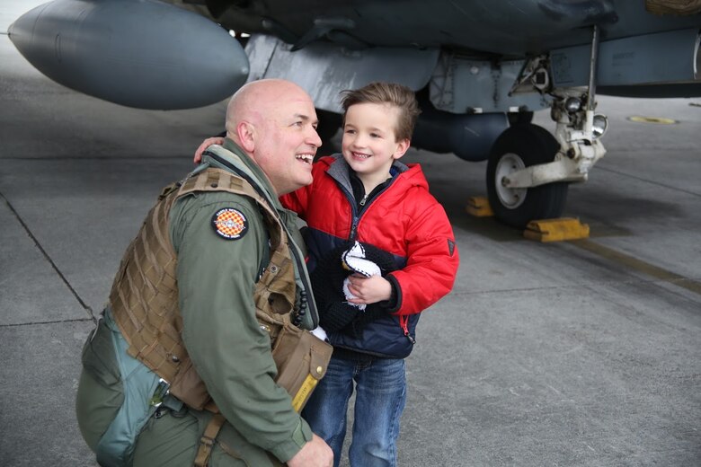 Lt. Col. Joseph Beals is greeted by his son Mason during a homecoming at Marine Corps Air Station Cherry Point, N.C., Dec. 19, 2016. A detachment of Marines from Marine Attack Squadron 542, Marine Aircraft Group 14, 2nd Marine Aircraft Wing, were attached to Marine Medium Tiltrotor Squadron 264 (Reinforced), Marine Aircraft Group 26, 2nd MAW, 22nd Marine Expeditionary Unit. The 22nd MEU, deployed with the Wasp Amphibious Ready Group, conducted naval operations in support of U.S. national security interests in Europe. Beals is the executive officer of VMA-542. (U.S. Marine Corps photo by Sgt. N.W. Huertas/ Released)