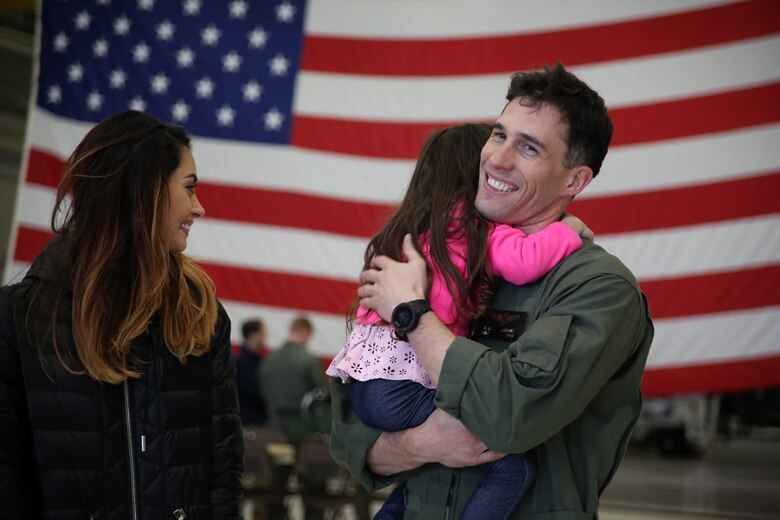 Maj. Matthew Martinez is welcomed by his family during a homecoming at Marine Corps Air Station Cherry Point, N.C., Dec. 19, 2016. A detachment of Marines from Marine Attack Squadron 542, Marine Aircraft Group 14, 2nd Marine Aircraft Wing, were attached to Marine Medium Tiltrotor Squadron 264 (Reinforced), Marine Aircraft Group 26, 2nd MAW, 22nd Marine Expeditionary Unit. The 22nd MEU, deployed with the Wasp Amphibious Ready Group, conducted naval operations in support of U.S. national security interests in Europe. Martinez is an AV-8B Harrier II pilot assigned to VMA-542.  (U.S. Marine Corps photo by Sgt. N.W. Huertas/ Released)