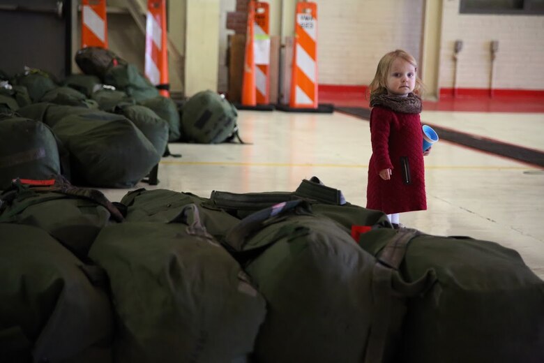 Brooklyn waits for her fathers return during a homecoming at Marine Corps Air Station Cherry Point, N.C., Dec. 20, 2016. Brooklyns father, Sgt. Matthew Segars, along with a detachment of Marines from Marine Attack Squadron 542, Marine Aircraft Group 14, 2nd Marine Aircraft Wing, were attached to Marine Medium Tiltrotor Squadron 264 (Reinforced), Marine Aircraft Group 26, 2nd MAW, 22nd Marine Expeditionary Unit. The 22nd MEU, deployed with the Wasp Amphibious Ready Group, conducted naval operations in support of U.S. national security interests in Europe. Segars is an Aircraft Electronic Countermeasures Systems Technician assigned to Marine Aviation Logistics Squadron 14, Marine Aircraft Group 14, 2nd Marine Aircraft Wing. (U.S. Marine Corps photo by Sgt. N.W. Huertas/ Released)