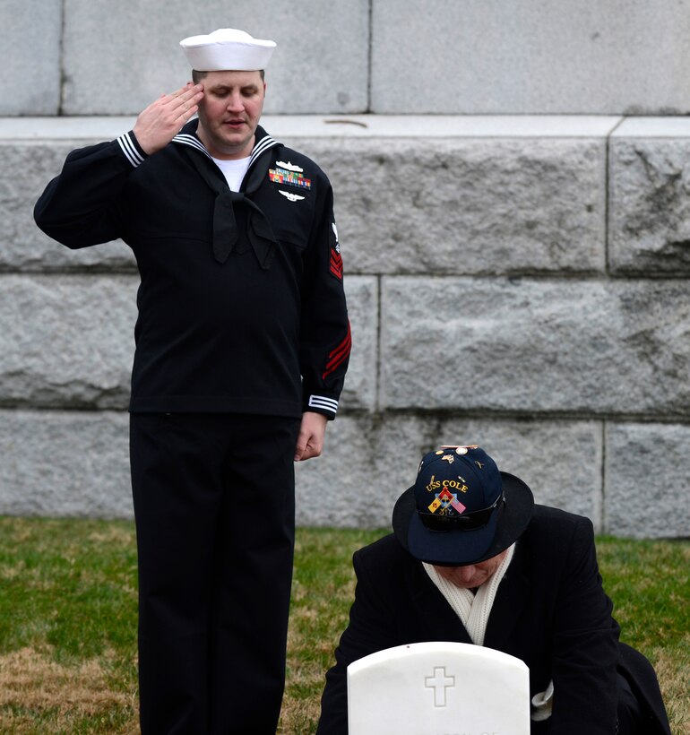 Retired U.S. Navy Master Chief Paul Abney, USS Cole survivor, honors his lost crew mates while U.S. Navy Petty Officer 1st Class Christopher Hooper, USS James E. Williams information systems administrator, salutes during a National Wreaths Across America Remembrance ceremony at Hampton National Cemetery in Hampton, Va., Dec. 17, 2016. Referring to the anonymous quote, “A person dies twice: once when they take their final break, and later, the last time their name is spoken,” volunteers were encouraged to say the names of the veterans as they placed the wreaths at their graves. (U.S. Air Force photo by Airman 1st Class Kaylee Dubois)