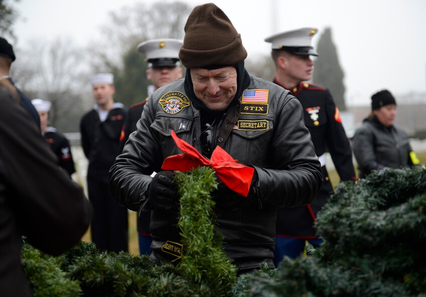 Bob “Sticks” Sadoff, V-Twin Cruiser Tidewater Chapter representative, volunteers for a National Wreaths Across America Remembrance ceremony at Hampton National Cemetery in Hampton, Va., Dec. 17, 2016. Volunteers from 30 different Hampton Roads organizations volunteered their time to prepare the wreaths for the ceremony. (U.S. Air Force photo by Airman 1st Class Kaylee Dubois)