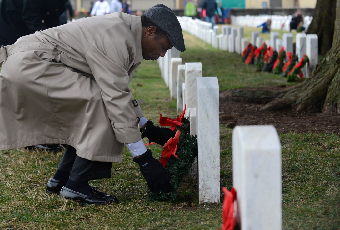 Donnie Tuck, Hampton City mayor, lays wreaths during a National Wreaths Across America Remembrance ceremony at Hampton National Cemetery in Hampton, Va., Dec. 17, 2016. On National Wreaths Across America Day, volunteers placed wreaths on veterans’ graves at over 1,100 locations throughout the U.S. (U.S. Air Force photo by Airman 1st Class Kaylee Dubois)