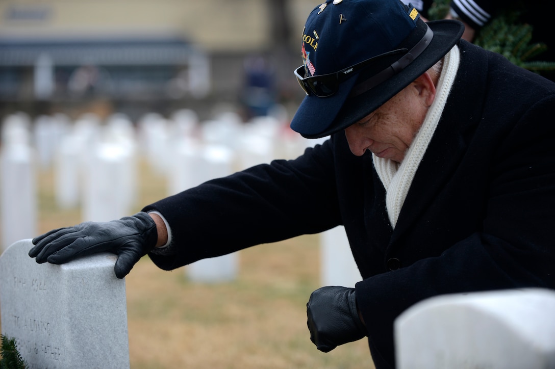 Retired U.S. Navy Master Chief Paul Abney, USS Cole survivor, honors his lost crew mates during a National Wreaths Across America Remembrance ceremony at Hampton National Cemetery in Hampton, Va., Dec. 17, 2016. Volunteers were encouraged to say the veteran’s name aloud and thank them for their service in hopes of keeping the memory of the veterans alive. (U.S. Air Force photo by Airman 1st Class Kaylee Dubois)