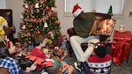 Defense Logistics Agency Aviation Customer Operations Mapping employee, Kevin Bettis, division chief, reads to children of Mapping employees Dec. 20, 2016. The children came to the installation to make Christmas cards to attach to gifts purchased by employees. The gifts are being donated to the children who are patients at Children’s Hospital of Richmond at Virginia Commonwealth University.