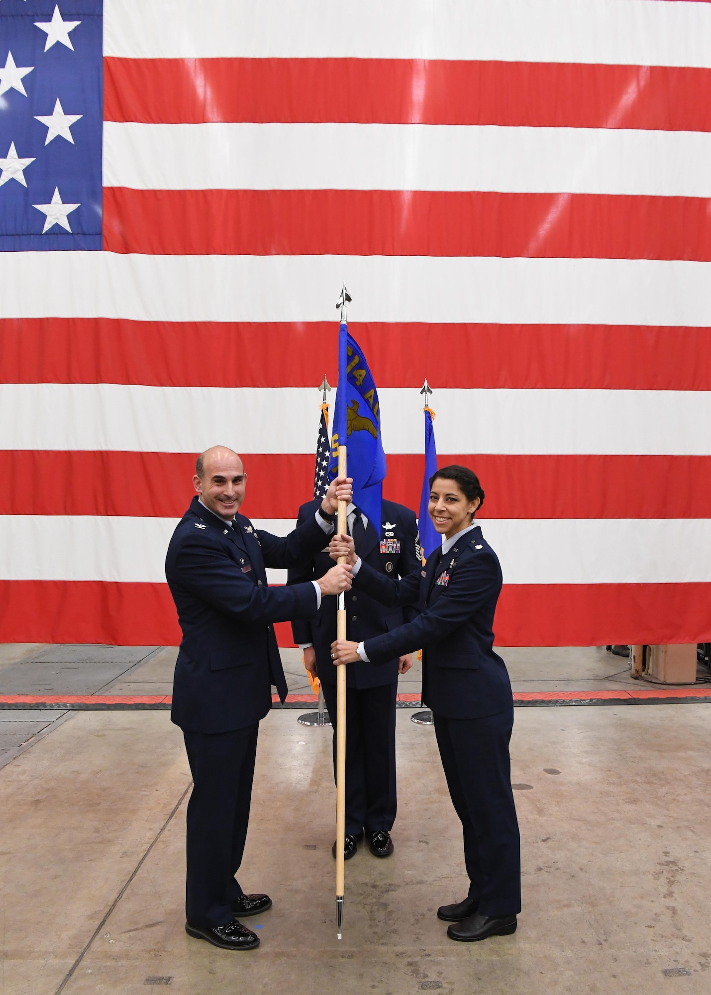 Col. Michael Manor, commander, 614th Air Operations Center and Joint Space Operations Center Director, passes the guidon to Lt. Col. Nicole Petrucci, commander, 614th Combat Training Squadron, during an activation ceremony Dec. 16, 2016 at Vandenberg Air Force Base, California.  As a new squadron under the 614th AOC, the 614th CTS will provide advanced training enabling the implementation and sustainment of Space Training Transformation and Space Mission Force initiatives and constructs across the unit. (U.S. Air Force photo by Capt. Nicholas Mercurio/Released)