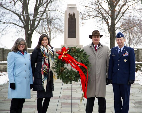 Amanda Wright Lane, Iris Wright Sunshine, Stephen Wright and Col. Bradley McDonald, 88th Air Base Wing commander, pose at the Wright Brothers Memorial on Wright-Patterson Air Force Base on Dec. 16, 2016, after laying a wreath in commemoration of the 113th anniversary of the Wright brothers’ first powered flight.  The Wrights are family members of the original aviators. (U.S. Air Force photo/R.J. Oriez)