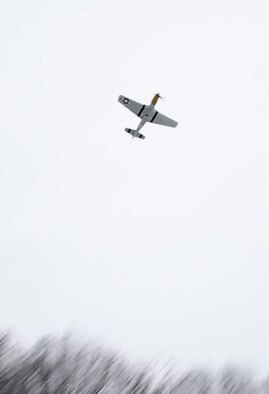 A perfectly timed flyover by a WWII era P-51D Mustang follows a wreath laying commemorating the 113th anniversary of the Wright brothers’ first powered flight at Wright Memorial Hill at Wright-Patterson Air Force Base on Dec. 16. The roar of the-51D Mustang, part of the Tri-State Warbird Museum near Cincinnati, marks the hour and minute of the first flight: 10:35 a.m. (Cox Media Group Ohio photo/Ty Greenlees)