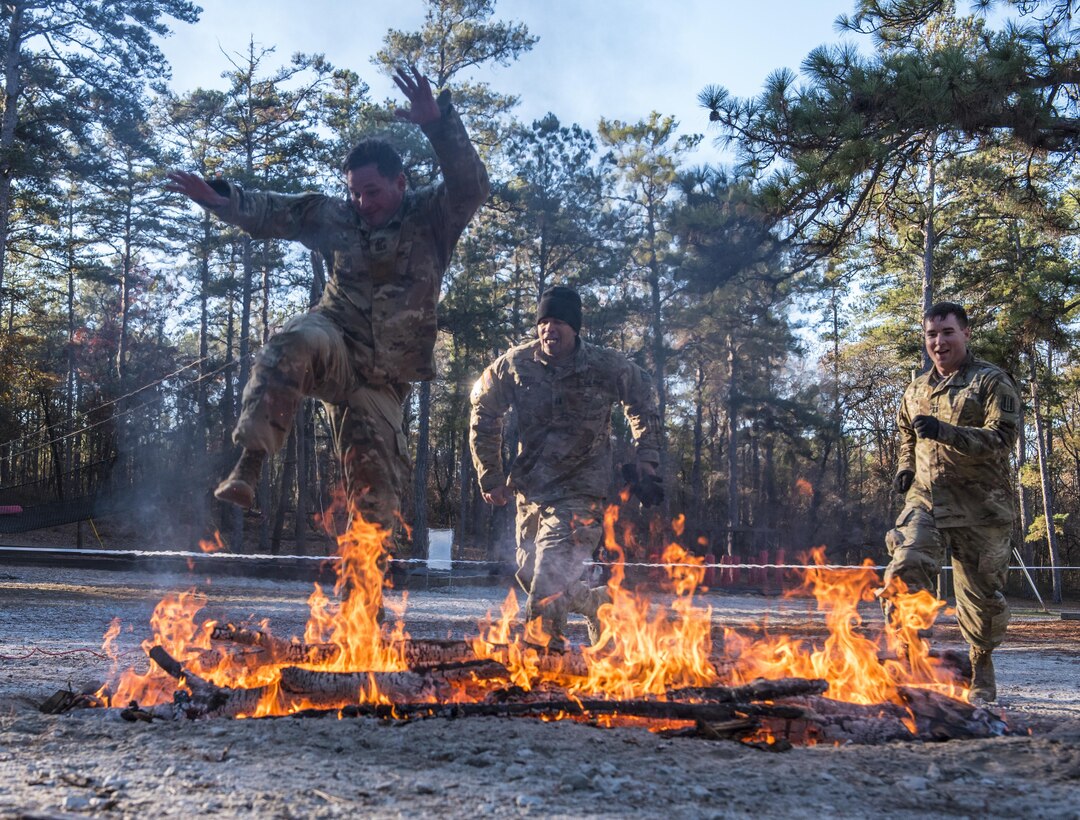 Soldiers participating in the Rubicon Command Team Challenge with the 193rd Infantry Brigade at Fort Jackson, S.C., finish the confidence course on the second day of the event by hurdling a fire pit, Dec. 9. The Rubicon Command Team Challenge was designed to exercise the leadership and combat skills for the company command teams within the 193rd Infantry Brigade, while at the same time building esprit de corps among the different teams. The challenge was held Dec. 8-9, 2016 at Fort Jackson, S.C.  (U.S. Army Reserve photo by Sgt. 1st Class Brian Hamilton/ released)