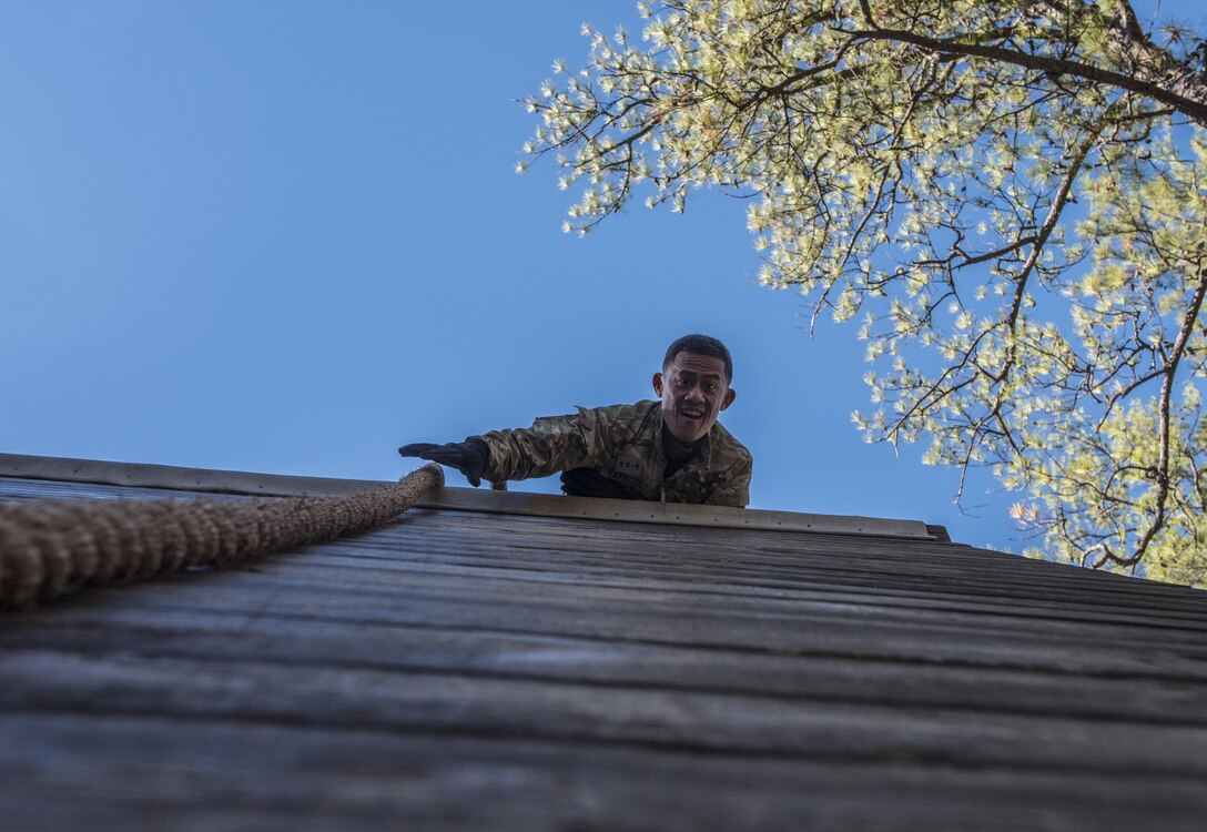 Capt. Glenn Barrozo, Headquarters, Headquarters Company, 193rd Infantry Brigade, attempts to grab the rope in an effort to complete the Berlin Wall obstacle on the confidence course during the Rubicon Command Team Challenge, Dec. 9. The Rubicon Command Team Challenge was designed to exercise the leadership and combat skills for the company command teams within the 193rd Infantry Brigade, while at the same time building esprit de corps among the different teams. The challenge was held Dec. 8-9, 2016 at Fort Jackson, S.C. (U.S. Army Reserve photo by Sgt. 1st Class Brian Hamilton/ released)
