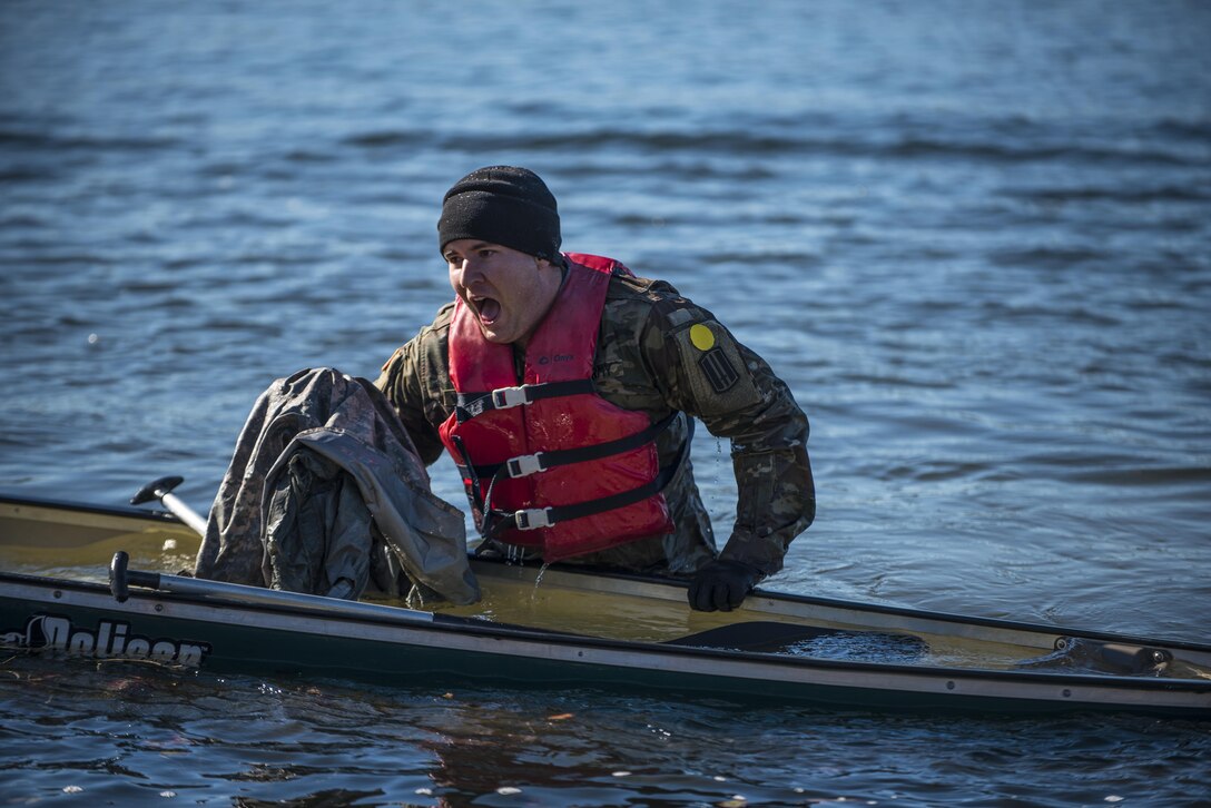 A Soldier participating in the Rubicon Command Team Challenge with the 193rd Infantry Brigade at Fort Jackson, S.C., tries to crawl back in his canoe after capsizing during the boat crossing event, Dec. 9. The boat crossing was the ninth and final event at the Rubicon Command Team Challenge. The challenge was designed to exercise the leadership and combat skills for the company command teams within the 193rd Infantry Brigade, while at the same time building esprit de corps among the different teams. The challenge was held Dec. 8-9, 2016 at Fort Jackson, S.C. (U.S. Army Reserve photo by Sgt. 1st Class Brian Hamilton/ released)