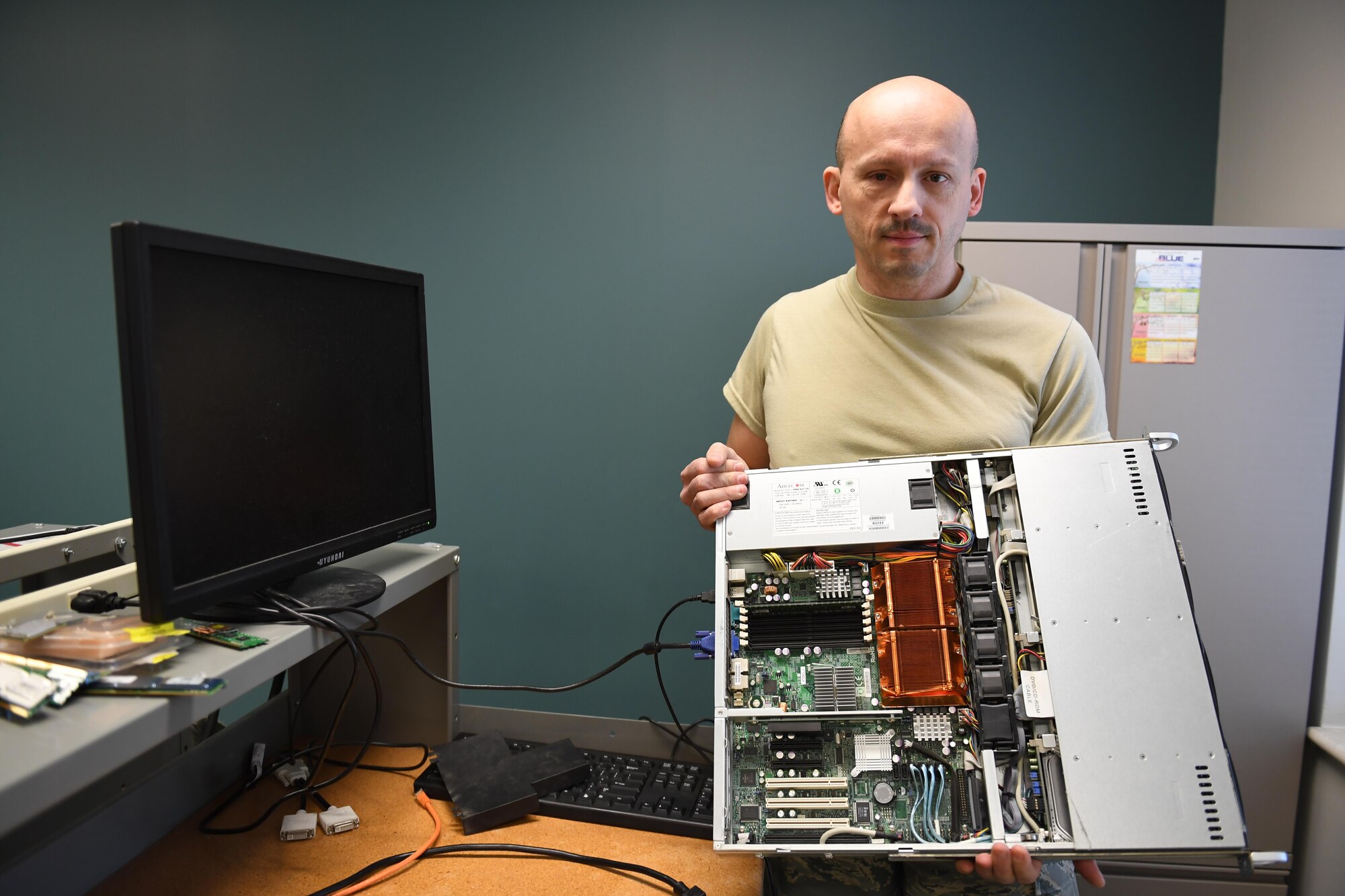 Brian Barnes, IT systems specialist with the 911th Communications Squadron, explains the new purpose of a server from an old mission at the Pittsburgh International Airport Air Reserve Station, Pennsylvania, Nov. 4, 2016. The 911th CS is currently working on repurposing this server to act as the server for future cyber operations training programs. (U.S. Air Force photo by Senior Airman Beth Kobily)