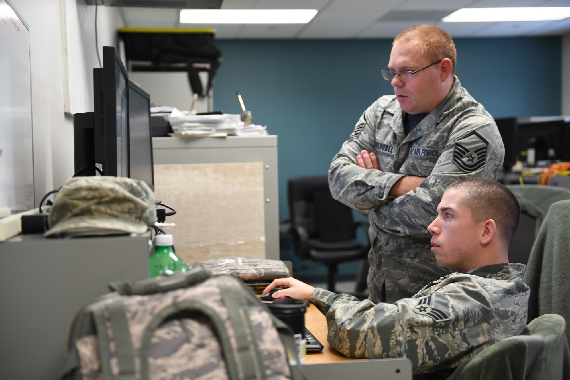 Master Sgt. Doug Obeldobel and Tech. Sgt. Andrew Wilson, client systems work center supervisor with the 911th Communications Squadron, participate in Cyber Tepper, a cyber exercise hosted by Carnegie Mellon University, at the Pittsburgh International Airport Air Reserve Station, Pennsylvania, Nov. 4, 2016. This exercise was a collaborative effort between Maj. Geoffrey Dobson, officer in charge of cyber assurance with the 911th CS, who works for the CERT division of the Software Engineering Institute at CMU, and Jerro Guo, PhD student with the Tepper School of Business. (U.S. Air Force photo by Senior Airman Beth Kobily)